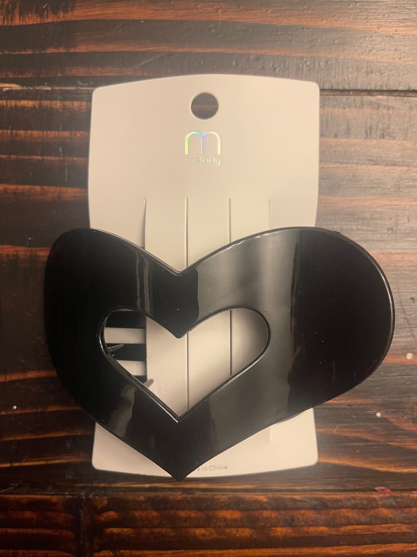 Large glossy heart-shaped hair claw clip with cutout center, chunky acrylic hair accessory for women.